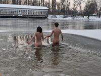 Russian traditional swimming in a winter ice hole