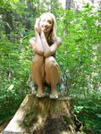 Blond amateur MILF posing at forest