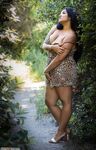 Ebony busty girl posing outdoors