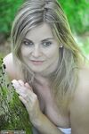 Blonde Melanie posing nude in the woods