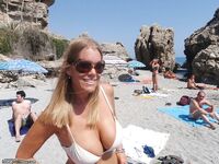 Curvy vacation MILF topless on beach