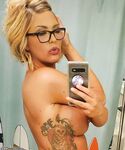 Sexy MILF with huge fake tits and glasses