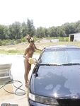 Naked girl at car washing