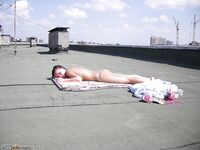 sunbathing naked at roof