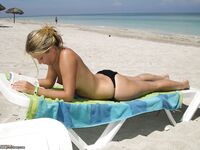 Amateur blonde sunbathing topless