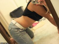 Asian Girl In Jeans Poses In The Mirror Showing Off Her Tight Body