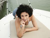 Curly-haired Beauty With Big Natural Tits Gets Sodomized On Yacht photos (Stacy Bloom)