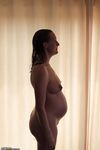 pregnant girl shows her growing belly