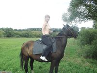 Teen topless horse-riding