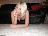 Sexy blonde babe posing on sofa 2
